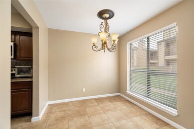 Dining room features tile flooring and a large win
