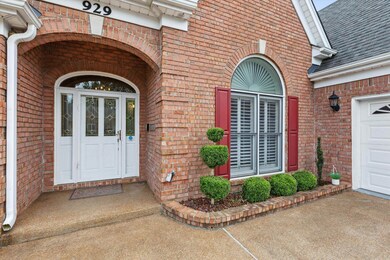 Doorway to property with brick siding and a shingled roof