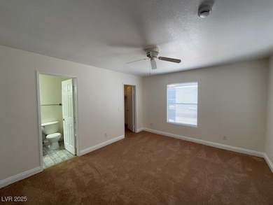 Bedroom with ceiling fan, new carpet bathroom access