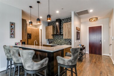 Kitchen featuring wall chimney range hood, tastefu
