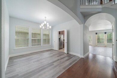 Unfurnished dining area with a chandelier and wood-type flooring
