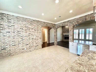 Kitchen featuring white cabinetry, light tile patt
