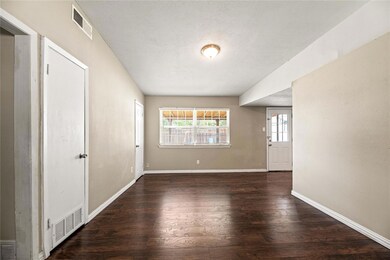 Empty room featuring dark wood-type flooring