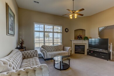 Large open Great Room light & bright with many windows, wood blinds, gas fire place opens to Dining Room, Hardwood floors. Wonderfully Clean!  Side load 2 car garage.