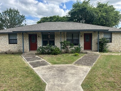 Single story home with a front yard, covered porc