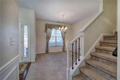 Foyer entrance featuring a chandelier, a healthy a