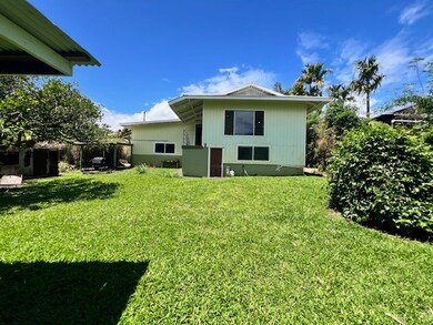 back of house shows the entire living space. Nice sized yard area with an enclosed basement area