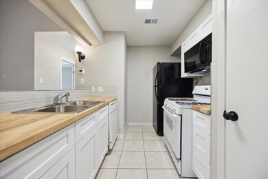 Kitchen featuring white appliances, a sink, white