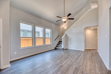 As you step across the threshold, you'll enter the spacious and inviting family room, greeted by a soaring vaulted ceiling and large double-paned windows that fill the space with abundant natural light.