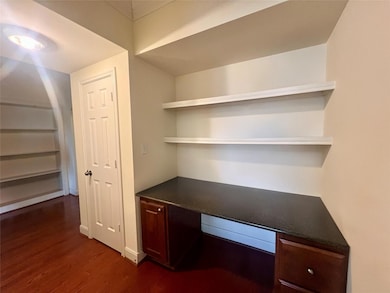 Unfurnished office featuring dark wood finished f