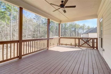 Wooden deck featuring ceiling fan