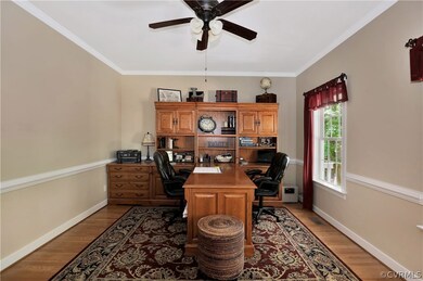 office features hard wood flooring, crown molding,