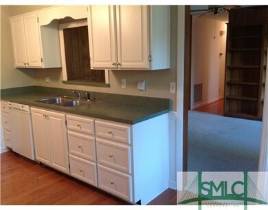 Kitchen. Watch the family in the den through the c