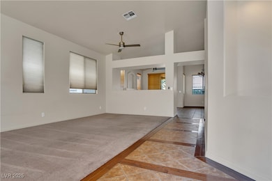 Empty room with inlaid floor details, baseboards,