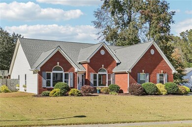 Traditional-style house with brick siding and roof with shingles