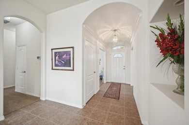 Tiled foyer entrance with arched walkways