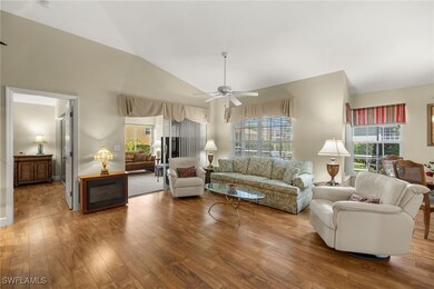 Living area featuring lofted ceiling, wood finishe
