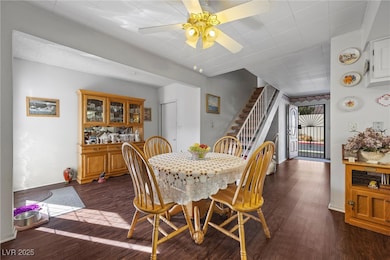 Dining space with dark wood finished floors, baseb