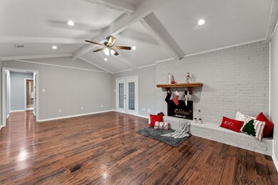 Living room featuring lofted ceiling with beams, w