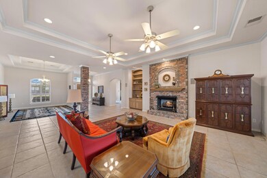Living area featuring a tray ceiling, light tile 