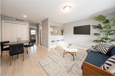Living room with baseboards, wood finished floors