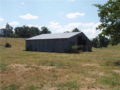 Exterior Front. Wood truss metal barn