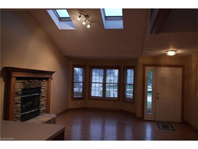 Living room with gas fireplace, bay windows, vault