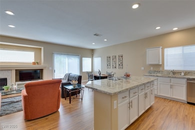 Kitchen featuring open floor plan, light wood fini