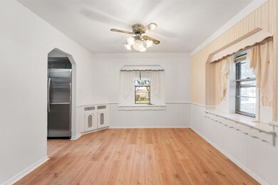 Cute dining room with a ceiling fan, decorative wi