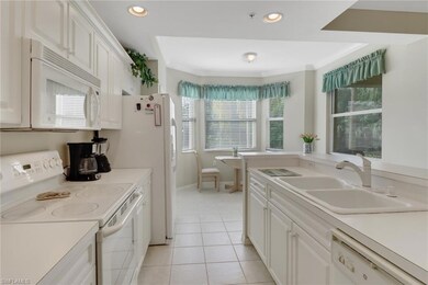 Kitchen with white appliances, plenty of natural l