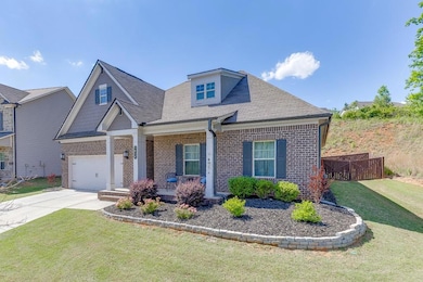Craftsman-style home with brick siding, concrete d