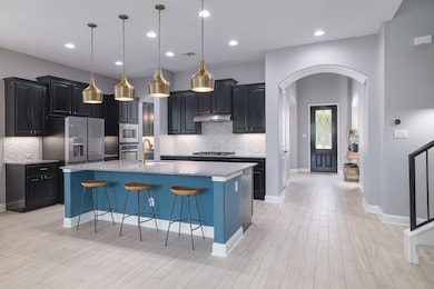 Kitchen with arched walkways, stainless steel app