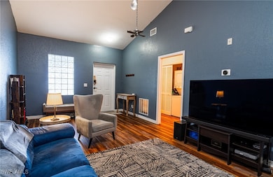Living room with hardwood / wood-style flooring an