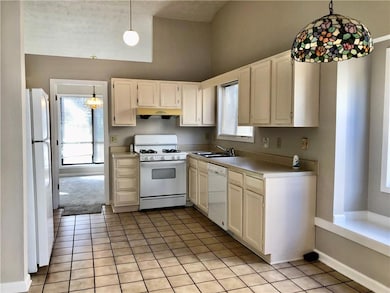 Kitchen featuring white appliances, under cabinet 