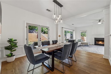Dining room featuring a large fireplace, wood fini