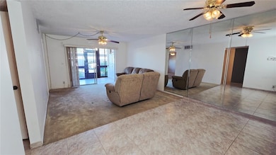Dining Room/Living Room Combo with view of the rear enclosed patio and access to the back door with loads of natural lighting.