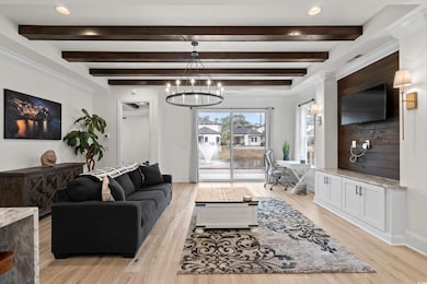 Living room featuring beamed ceiling, a notable ch