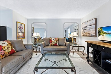 Living area with wood finished floors and a textured ceiling
