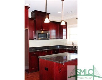 Kitchen. Wood stained cabinetry with crown molding