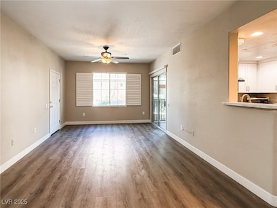 Living room with dark wood-style floors, ceiling fan, and recessed lighting