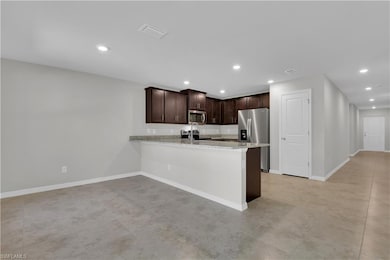 Kitchen with stainless steel appliances, dark brow