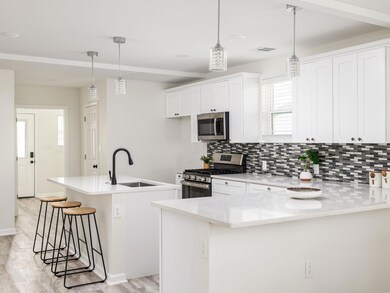Kitchen featuring visible vents, backsplash, a br