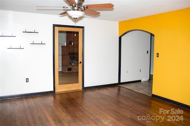 Entry living space.  Kitchen through arch way, family room on left.
