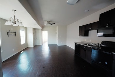 Kitchen featuring dark wood-style flooring, black