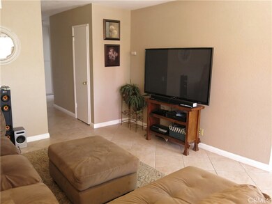 Spacious living room with upgraded tile floors and custom paint