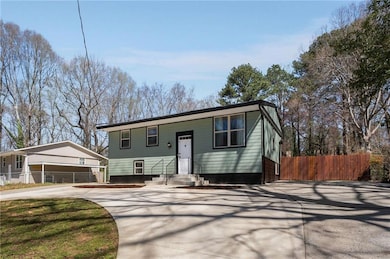 Raised ranch featuring driveway and fence