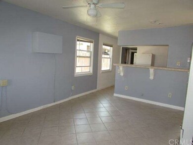 View from the front door of the living room. Tiled
