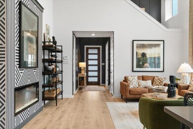 Living room with a high ceiling, light wood-type 