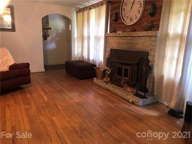 Wood flooring with a wood burning fireplace in liv