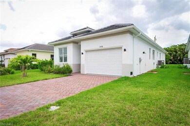 View of property exterior with stucco siding, a yard, decorative driveway, an attached garage, and a tile roof